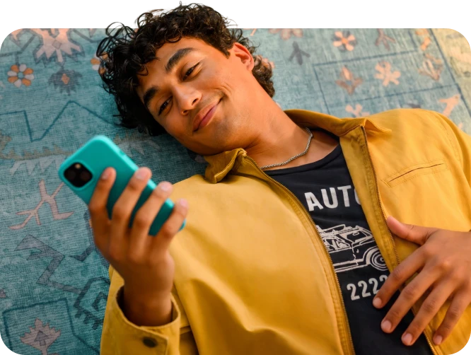 A person relaxing while checking their Upstart rate on a phone